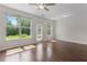 Spacious living room with hardwood floors, a ceiling fan, and bright windows at 5843 Taka Ln, Lithonia, GA 30038