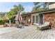 Relaxing back deck with seating, a lounge chair, and lush green trees at 1263 Blueberry Trl, Decatur, GA 30033
