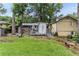 Backyard with mature trees, patio, deck, and lush lawn at 1263 Blueberry Trl, Decatur, GA 30033