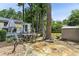Backyard with mature trees, stone patio, and outdoor dining area at 1263 Blueberry Trl, Decatur, GA 30033
