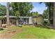Sprawling backyard with green lawn, mature trees, deck, and patio at 1263 Blueberry Trl, Decatur, GA 30033