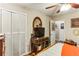 Neat bedroom featuring a closet with bi-fold doors, TV on a desk, and hardwood floors at 1263 Blueberry Trl, Decatur, GA 30033