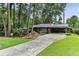Charming brick home with a long driveway, a carport, and a well-manicured lawn at 1263 Blueberry Trl, Decatur, GA 30033