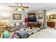 Spacious living room featuring a comfortable sofa, a television, and a ceiling fan for added comfort at 1263 Blueberry Trl, Decatur, GA 30033
