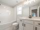 Bright bathroom with white subway tile shower, a single sink vanity, and a white toilet at 1731 Fulmont Cir, Mableton, GA 30126