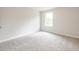 Bright bedroom featuring neutral carpeting and a window, creating a relaxing space at 1731 Fulmont Cir, Mableton, GA 30126