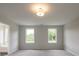 Bright bedroom with two windows and neutral carpeting, offering a calming atmosphere at 1731 Fulmont Cir, Mableton, GA 30126
