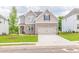 Two-story home with brick accents, attached two-car garage, and landscaped front yard at 1731 Fulmont Cir, Mableton, GA 30126