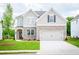 Charming two-story home with brick accents, a two-car garage, and a well-manicured lawn at 1731 Fulmont Cir, Mableton, GA 30126