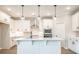 Spacious white kitchen with large island, stainless steel appliances, and modern lighting at 1731 Fulmont Cir, Mableton, GA 30126