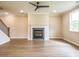 Spacious living room with modern flooring, a fireplace, and views from a large window at 1731 Fulmont Cir, Mableton, GA 30126