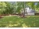 Large backyard with a wooden fence, grassy area and a deck at 410 Sheringham Ct, Roswell, GA 30076