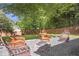 Cozy backyard firepit area surrounded by lush landscaping and mature trees at 410 Sheringham Ct, Roswell, GA 30076