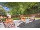 Inviting backyard with gravel fire pit, seating, and lush landscaping for relaxing outdoor living at 410 Sheringham Ct, Roswell, GA 30076