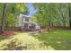 A beautiful backyard with a wooden deck and outdoor seating area surrounded by a privacy fence at 410 Sheringham Ct, Roswell, GA 30076