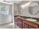 Bright bathroom with double sinks, granite countertops and a window for natural light at 410 Sheringham Ct, Roswell, GA 30076