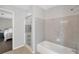 Clean bathroom with shower and tub combination and access to bedroom at 410 Sheringham Ct, Roswell, GA 30076
