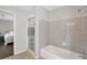 Bright bathroom features a shower-tub combination with tile surround at 410 Sheringham Ct, Roswell, GA 30076