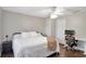 Cozy bedroom showcases wood floors, ceiling fan, and workspace for maximum functionality at 410 Sheringham Ct, Roswell, GA 30076