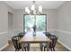 Bright dining room featuring modern chandelier, wood table, and neutral wall color, perfect for Gathering meals and gatherings at 410 Sheringham Ct, Roswell, GA 30076