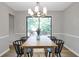Bright dining room features an elegant chandelier and large glass doors to the outdoor space at 410 Sheringham Ct, Roswell, GA 30076