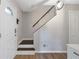 Bright entryway featuring hardwood floors, a staircase, and a modern light fixture at 410 Sheringham Ct, Roswell, GA 30076