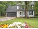 Charming two-story home featuring a well-manicured lawn, attached garage and mature trees at 410 Sheringham Ct, Roswell, GA 30076