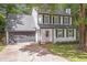 Attractive two-story home with well-maintained lawn, dark shutters, and attached garage at 410 Sheringham Ct, Roswell, GA 30076