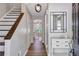 Entryway featuring hardwood floors, modern light fixture and decorative mirror at 410 Sheringham Ct, Roswell, GA 30076