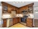 Well-lit kitchen featuring stainless steel appliances, stylish cabinetry, and a tile backsplash at 410 Sheringham Ct, Roswell, GA 30076