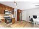 Updated kitchen with modern appliances, tile backsplash, granite countertops, and adjacent dining area at 410 Sheringham Ct, Roswell, GA 30076