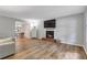 Bright living room featuring a decorative fireplace, and hardwood floors at 410 Sheringham Ct, Roswell, GA 30076
