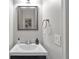 Modern powder room with stylish vanity, framed mirror, and updated fixtures, offering a touch of elegance at 410 Sheringham Ct, Roswell, GA 30076