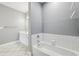 Bright bathroom featuring bathtub, white vanity, and large mirror at 4203 Stratford Commons # 4203, Decatur, GA 30033