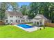 Backyard features a pool, lush green lawn, and pristine exterior, creating an ideal outdoor living space at 440 Junction Trak, Roswell, GA 30075