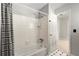 Clean bathroom with a shower-tub combo, white tile, and a decorative shower curtain at 440 Junction Trak, Roswell, GA 30075