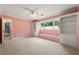 Inviting bedroom featuring built-in bookshelves, window bench seat and lots of natural light at 440 Junction Trak, Roswell, GA 30075
