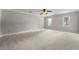 Spacious bedroom featuring neutral walls, plush carpet, and plenty of natural light from the two windows at 440 Junction Trak, Roswell, GA 30075