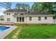 A back exterior view shows the home's layout, deck, pool, and manicured lawn, highlighting the spacious outdoor area at 440 Junction Trak, Roswell, GA 30075