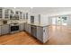 Bright kitchen with stainless steel appliances and granite countertops connected to the living room at 440 Junction Trak, Roswell, GA 30075