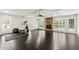 Open living area with a stone fireplace, ceiling fan, and lots of natural light at 440 Junction Trak, Roswell, GA 30075