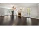 Bright living room with dark hardwood floors, a fireplace, and large windows with shutter-style blinds at 440 Junction Trak, Roswell, GA 30075