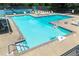 Community pool featuring a lounge chairs, umbrellas, and a tennis court, enhancing resort-style living at 440 Junction Trak, Roswell, GA 30075