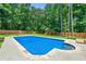 Backyard pool is surrounded by a concrete patio, wooden fence, and green lawn perfect for outdoor relaxation and play at 440 Junction Trak, Roswell, GA 30075