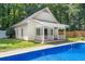A luxurious pool and pool house provides outdoor entertainment space at 440 Junction Trak, Roswell, GA 30075