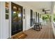 Inviting porch with rocking chairs, ceiling fans, and stylish front door with glass panels at 440 Junction Trak, Roswell, GA 30075