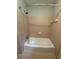 Clean bathroom featuring a bathtub with light pink tiling at 882 Campbell Rd, Covington, GA 30014