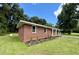 A charming brick home featuring new landscaping, green grass and a newly installed roof at 882 Campbell Rd, Covington, GA 30014