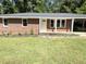 Attractive brick home with a covered carport, new landscaping and a freshly painted white front door at 882 Campbell Rd, Covington, GA 30014