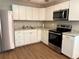 Modern kitchen featuring stainless steel appliances, white cabinets, and granite countertops at 882 Campbell Rd, Covington, GA 30014